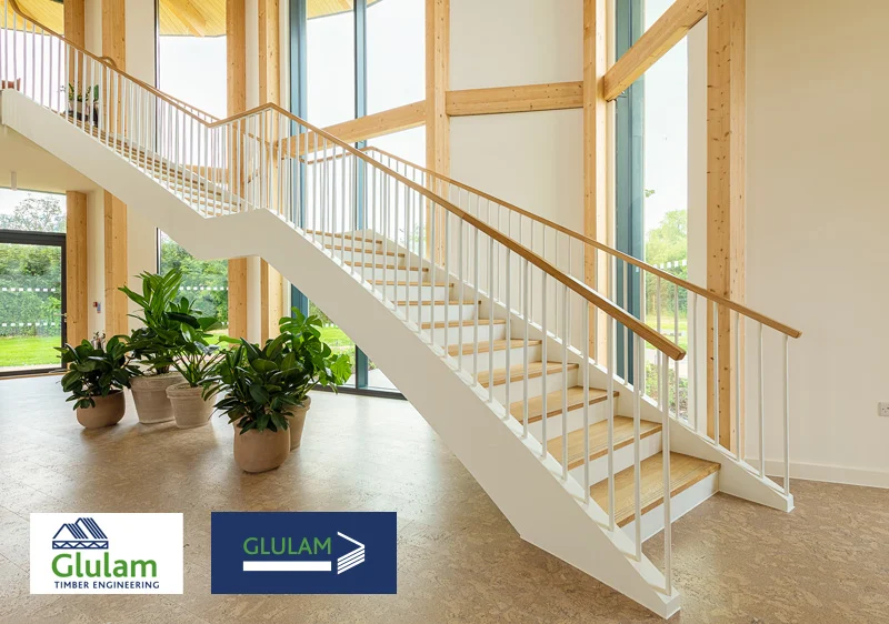 sleek wooden staircase in a room with plenty of windows