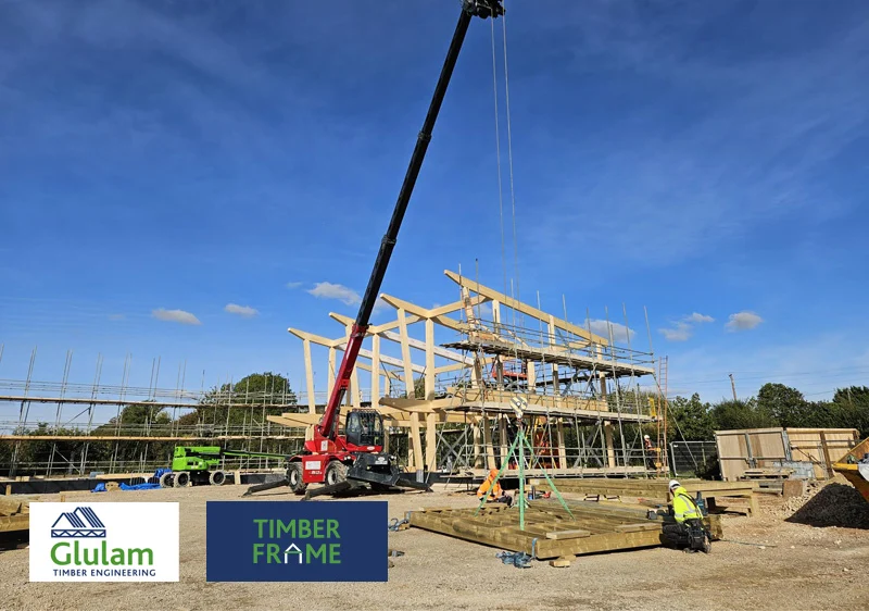 timber structure in construction with a crane and workers