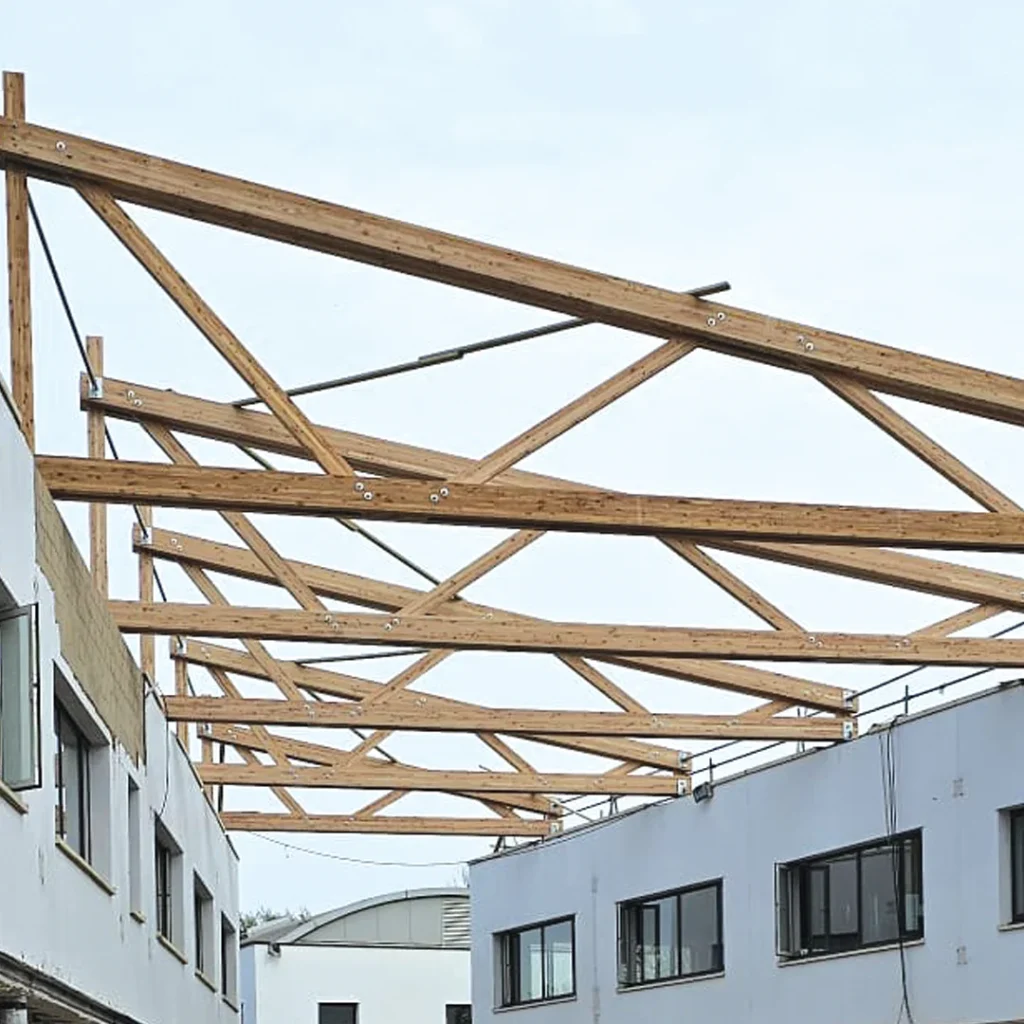 Wooden roof beams being installed