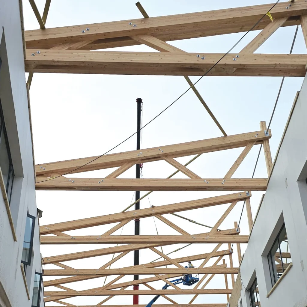 Wooden roof beams being installed